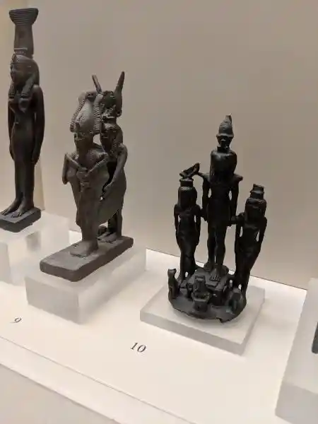  Ancient Egyptian copper alloy votive group of winged Isis with Osiris (no. 9) and Horus, Isis, Nephtys and Harpokrates (no. 10)